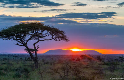 Africa-Sunset Peeking Through Clouds
