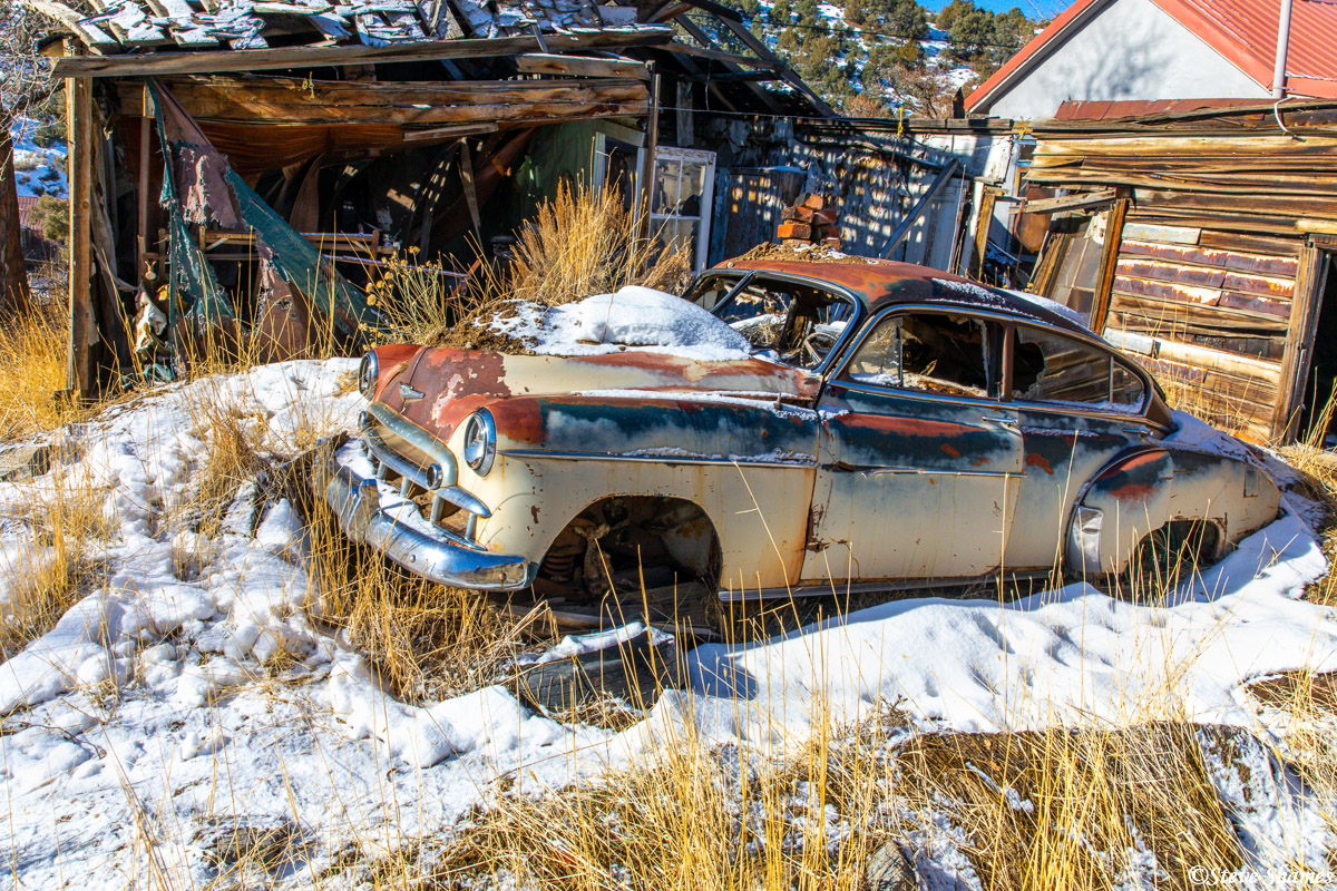 I am always on the lookout for old junked car scenes that are rich in character. I think this old Chevy in Austin Nevada was...