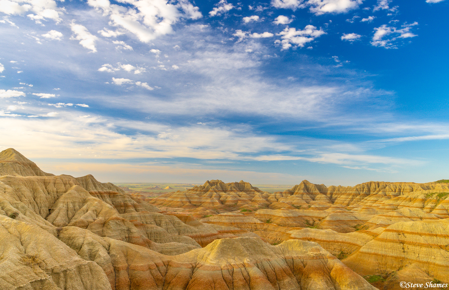 A big beautiful sky over a colorful section of the Badlands.