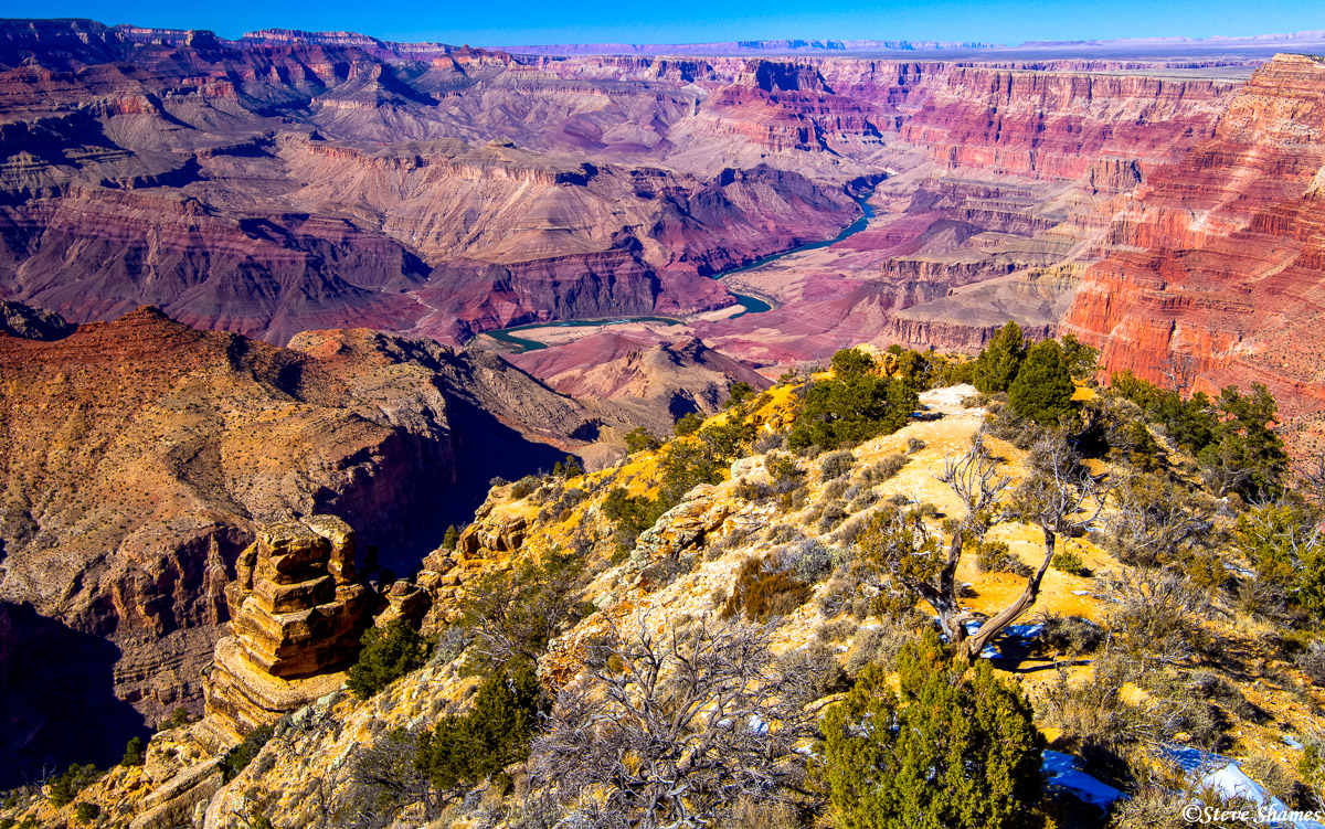 The mighty Colorado River way down below, winds through the Grand Canyon.