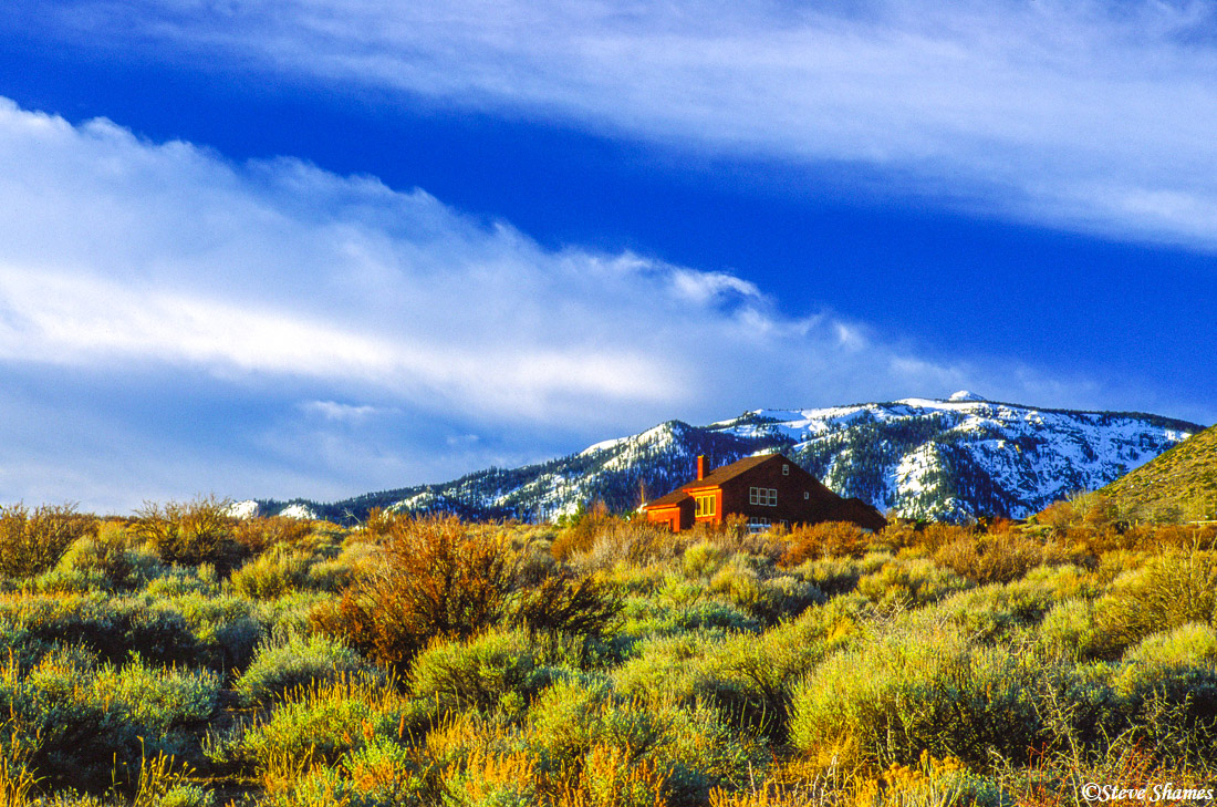 I like this scene with the sagebrush, the house, the mountains, and the great sky.