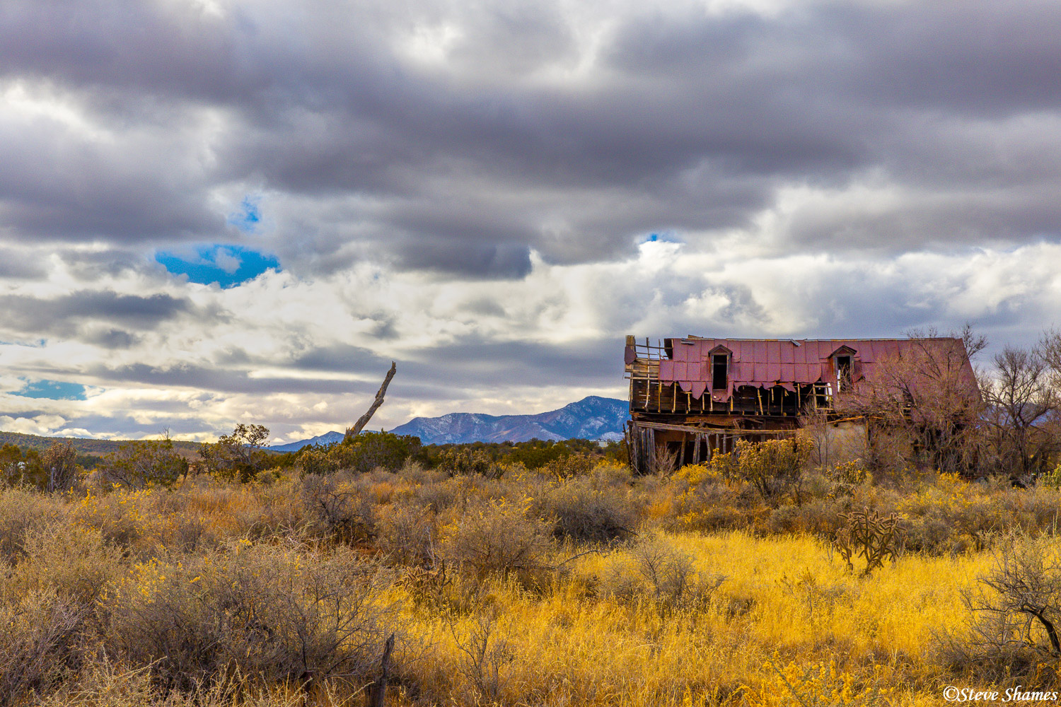 A dilapidated old barn against a stormy sky in rural Torrance County New Mexico.