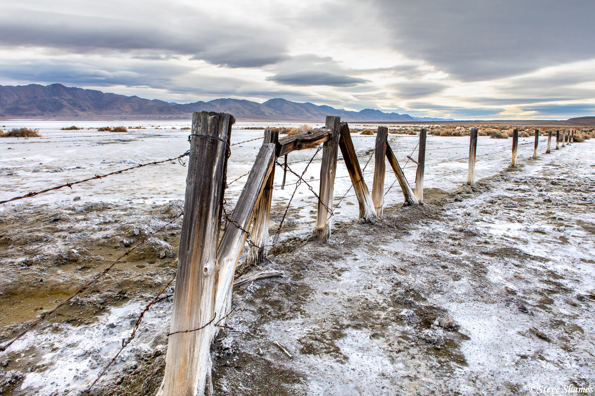 A rustic fence through the salty and dry Winnemucca Lake.