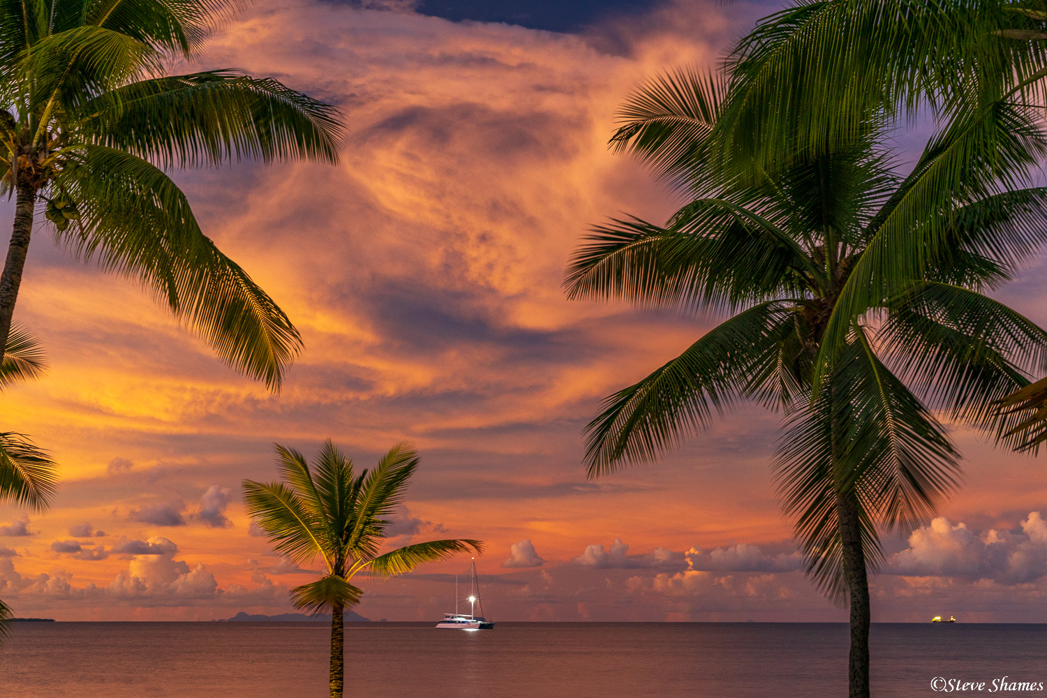 A boat out at sea makes a nice addition to this sunset scene in Fiji.